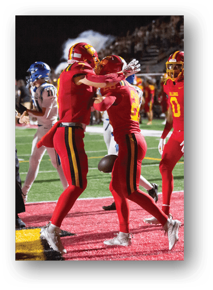 A group of football players celebrating a touchdown. Description generated by AI