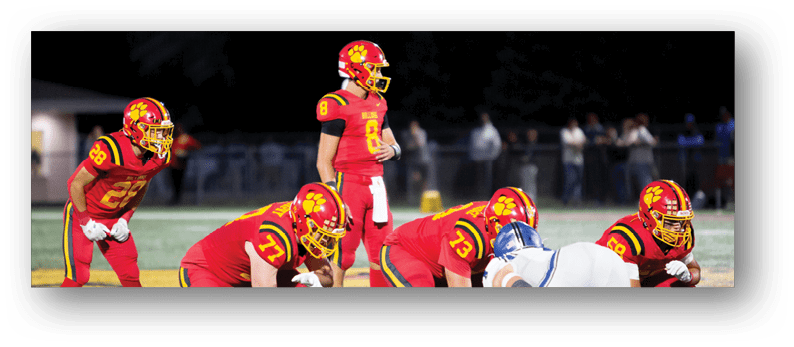 A group of football players on a field. Description generated by AI