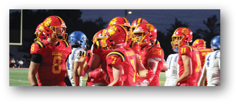 A group of football players on a field. Description generated by AI