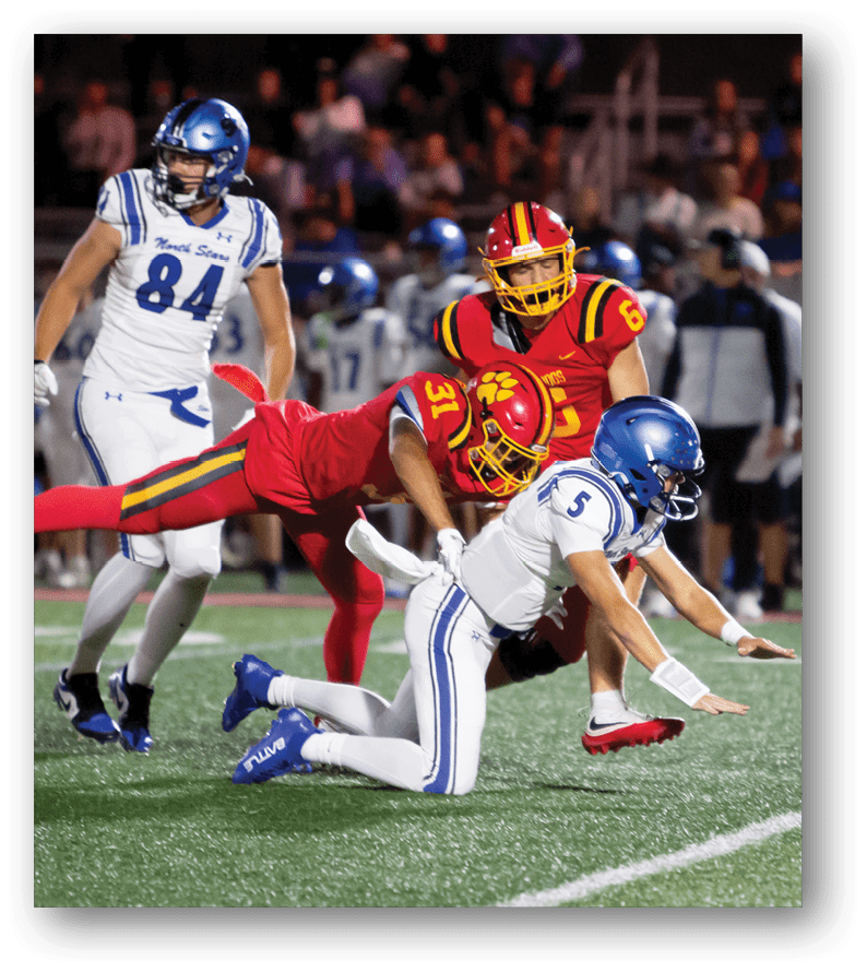A group of football players on a field. Description generated by AI