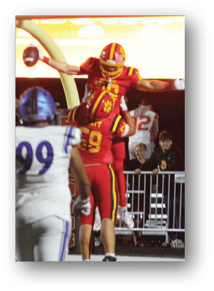 A group of football players celebrating a touchdown. Description generated by AI