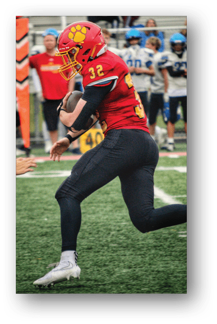 A football player catching a ball. Description generated by AI