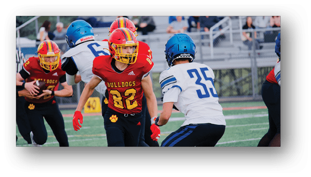 A group of football players on a field. Description generated by AI