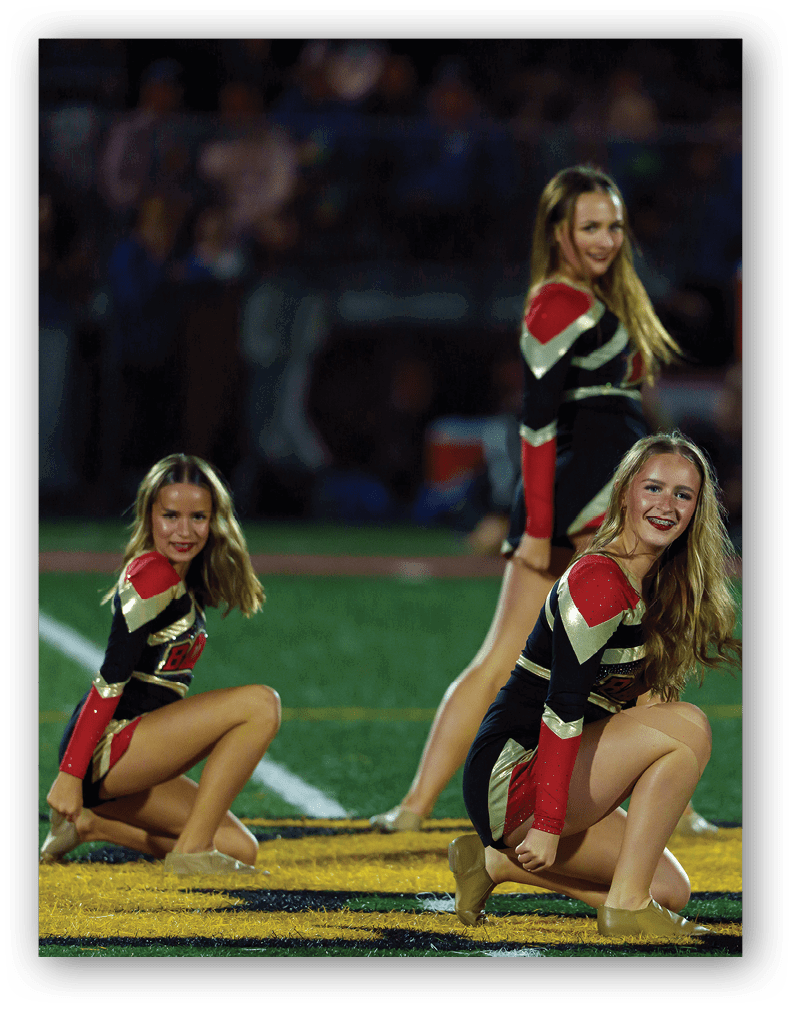 A group of football players on a field. Description generated by AI