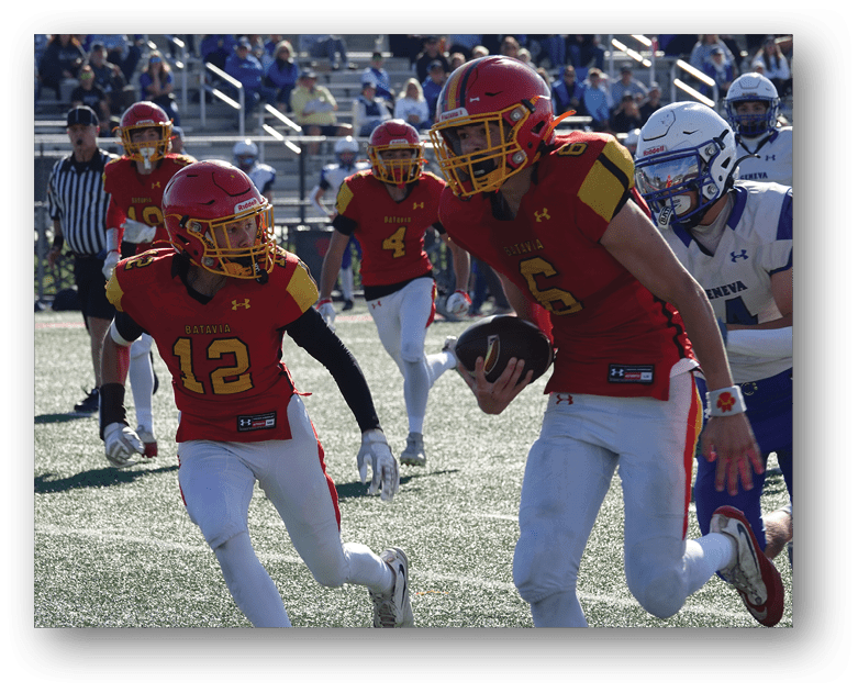 Three football players in blue and white uniforms running on a field. Description generated by AI