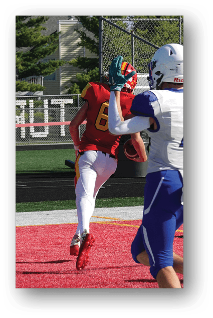 A football player catching a ball. Description generated by AI