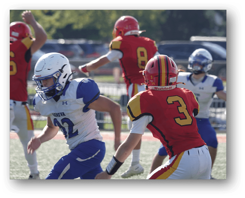 Three football players in blue and white uniforms running on a field. Description generated by AI