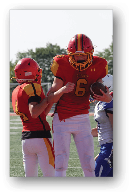 A football player catching a ball. Description generated by AI