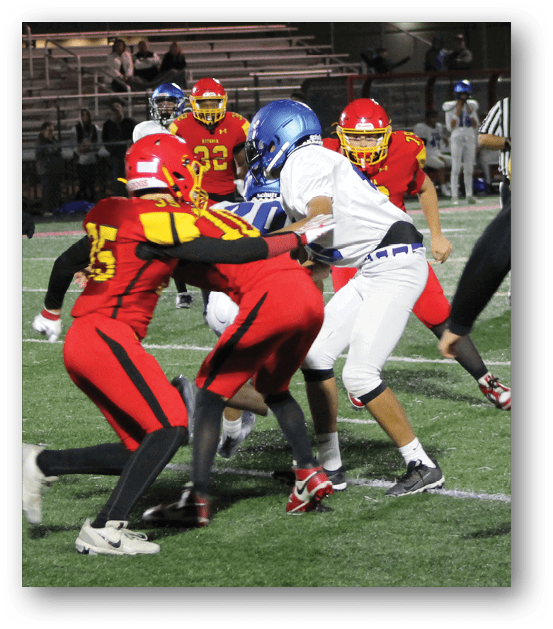 Three football players in blue and white uniforms running on a field. Description generated by AI
