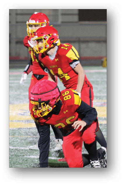 A football player catching a ball. Description generated by AI