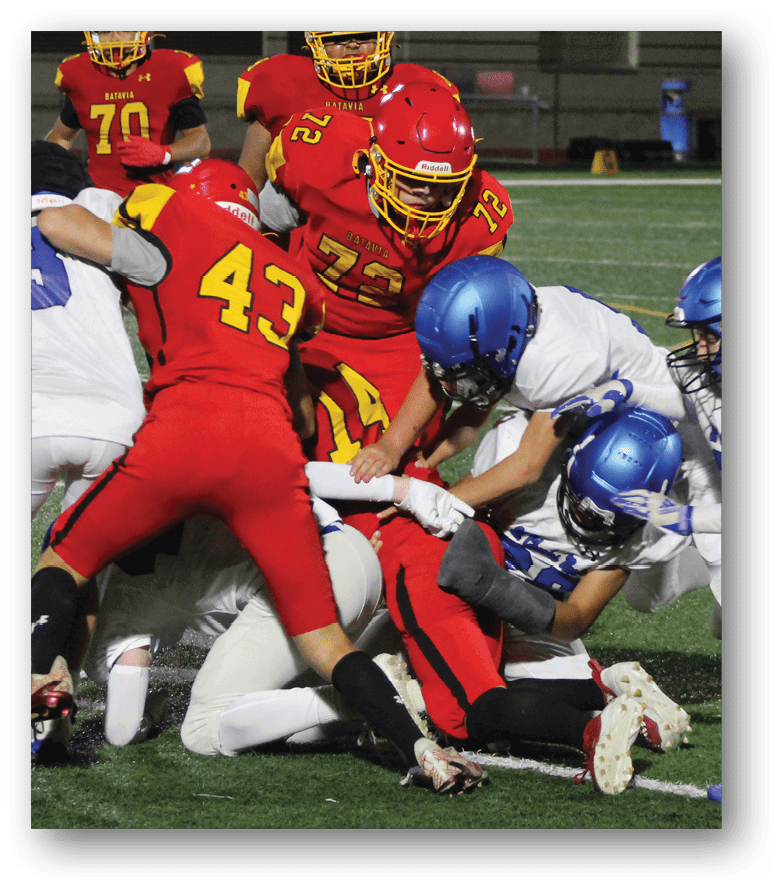 Three football players in blue and white uniforms running on a field. Description generated by AI