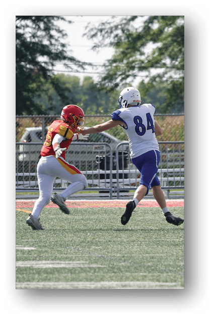 A football player catching a ball. Description generated by AI
