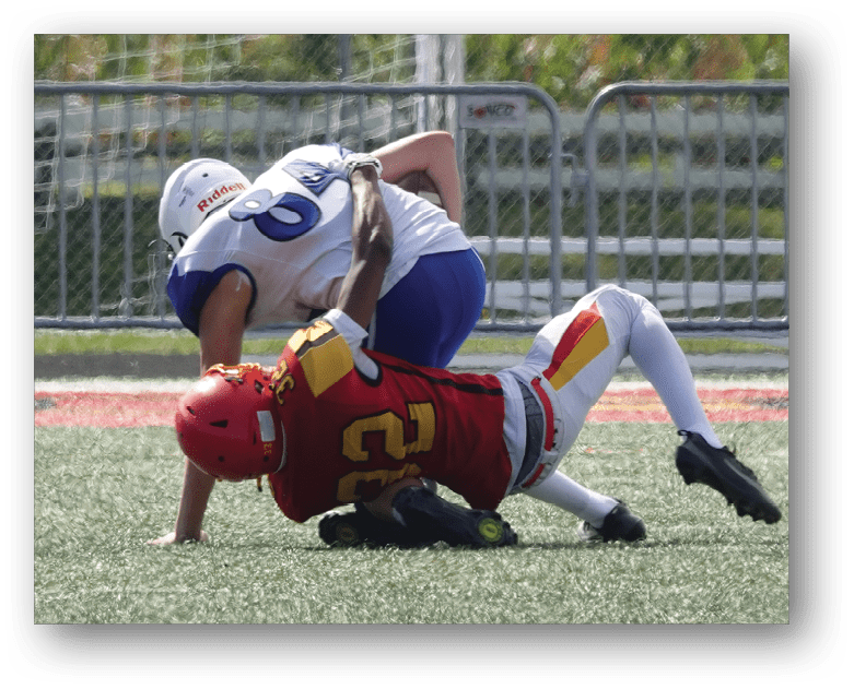 Three football players in blue and white uniforms running on a field. Description generated by AI