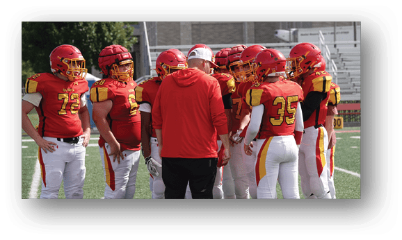 A group of football players on a field. Description generated by AI