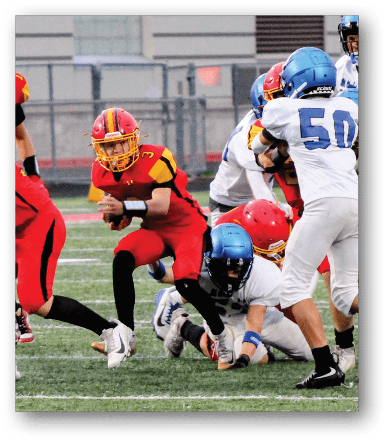 Three football players in blue and white uniforms running on a field. Description generated by AI