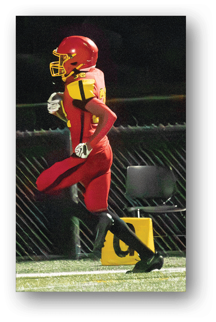 A football player catching a ball. Description generated by AI