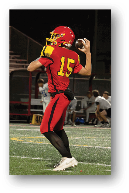 A football player catching a ball. Description generated by AI