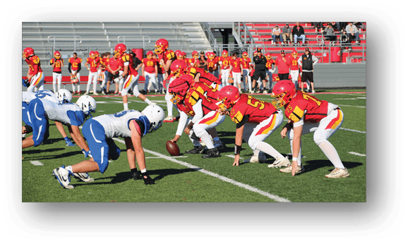 A group of football players on a field. Description generated by AI
