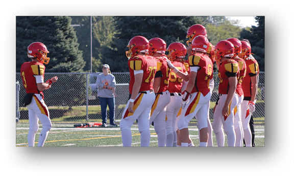 A group of football players on a field. Description generated by AI