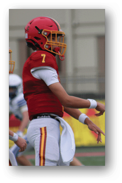 A football player catching a ball. Description generated by AI