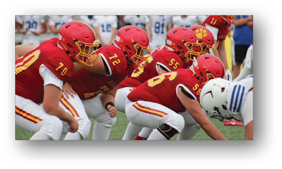 A group of football players on a field. Description generated by AI