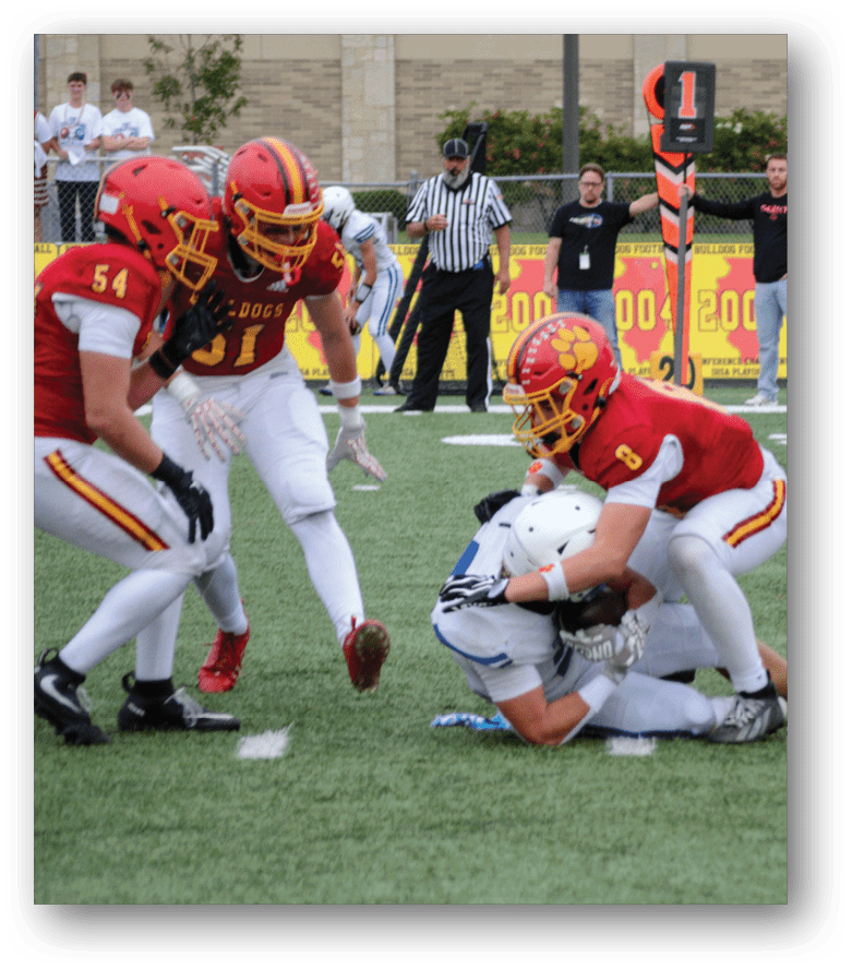Three football players in blue and white uniforms running on a field. Description generated by AI