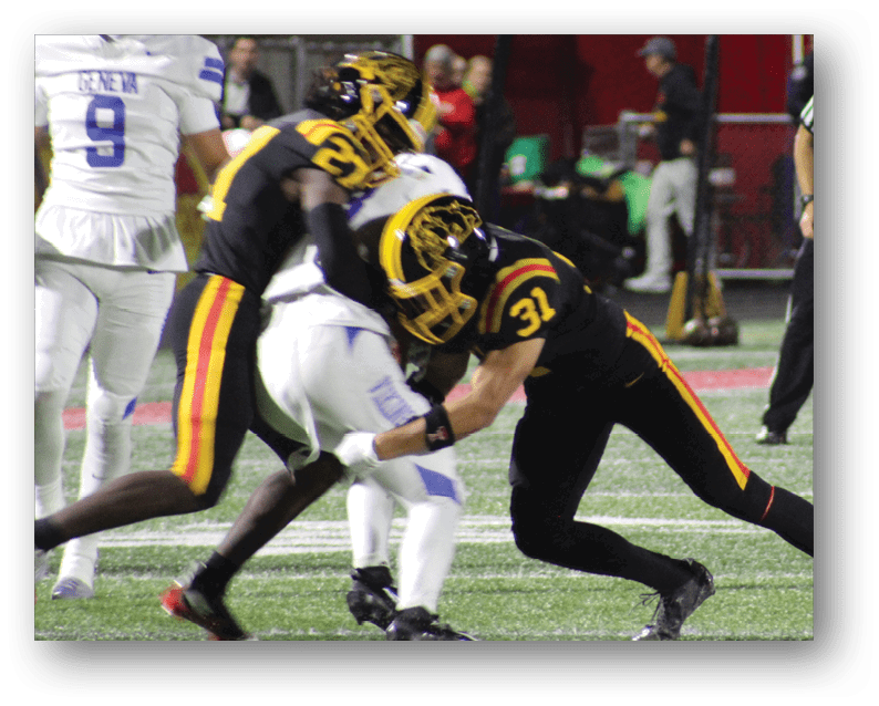 A group of football players on a field. Description generated by AI