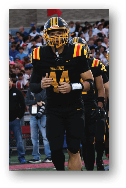 Two football players wearing blue and white uniforms. Description generated by AI