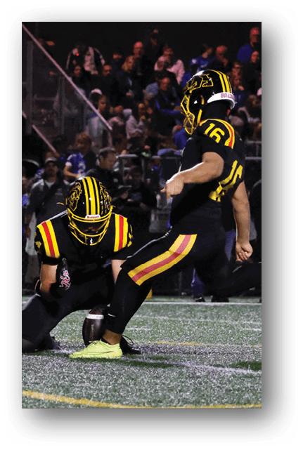 Two football players wearing blue and white uniforms. Description generated by AI