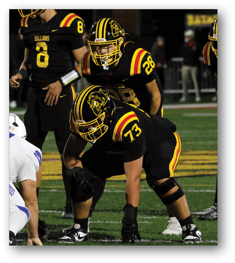 A group of football players on a field. Description generated by AI