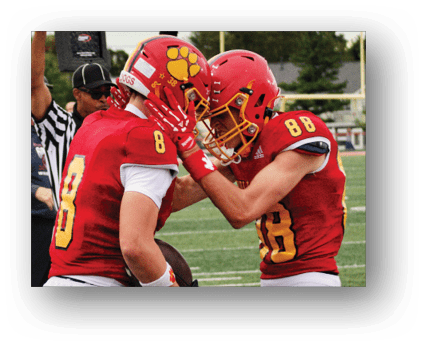 A group of football players on a field. Description generated by AI