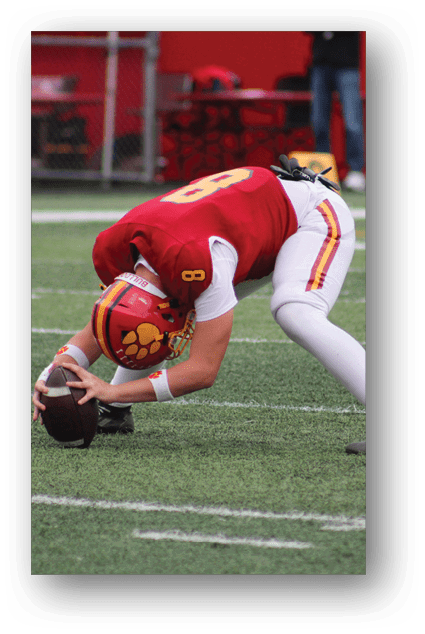 A football player catching a ball. Description generated by AI