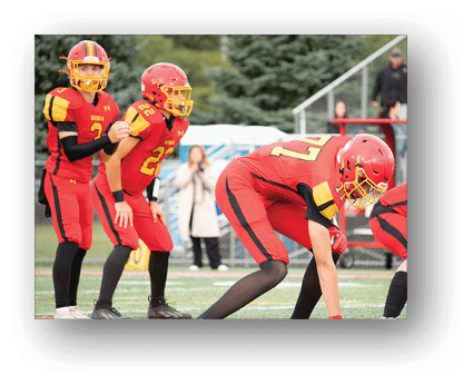 A group of football players on a field. Description generated by AI