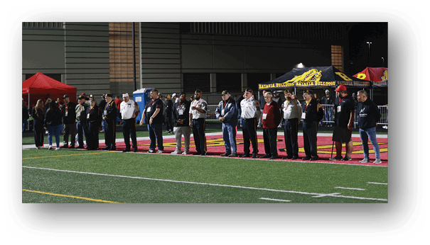 A group of football players on a field. Description generated by AI