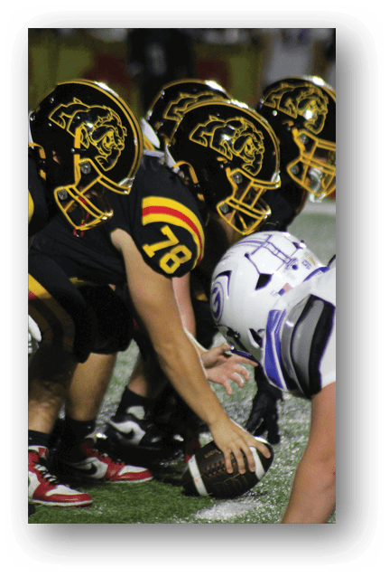 Two football players wearing blue and white uniforms. Description generated by AI