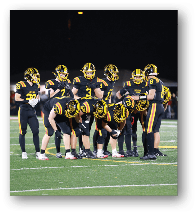 A group of football players on a field. Description generated by AI