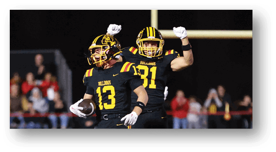 A group of football players celebrating a touchdown. Description generated by AI