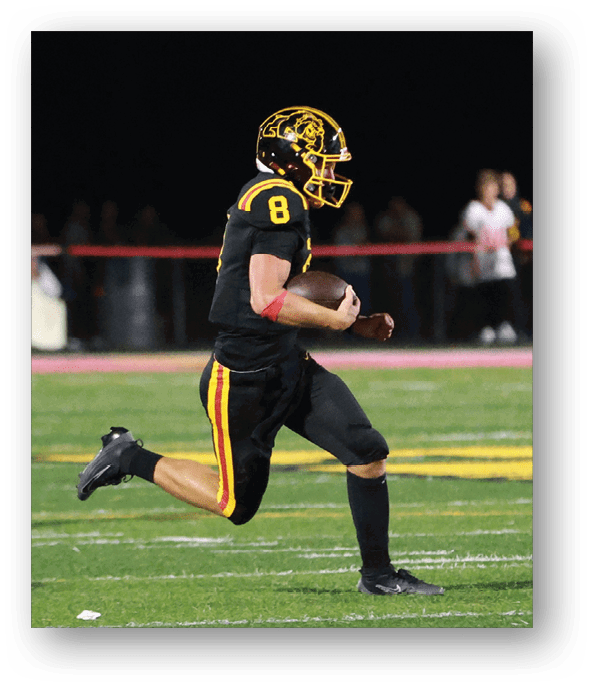 A football player running on the field. Description generated by AI