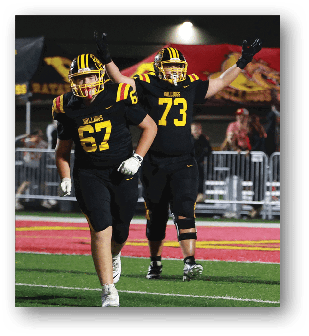 A group of football players on a field. Description generated by AI