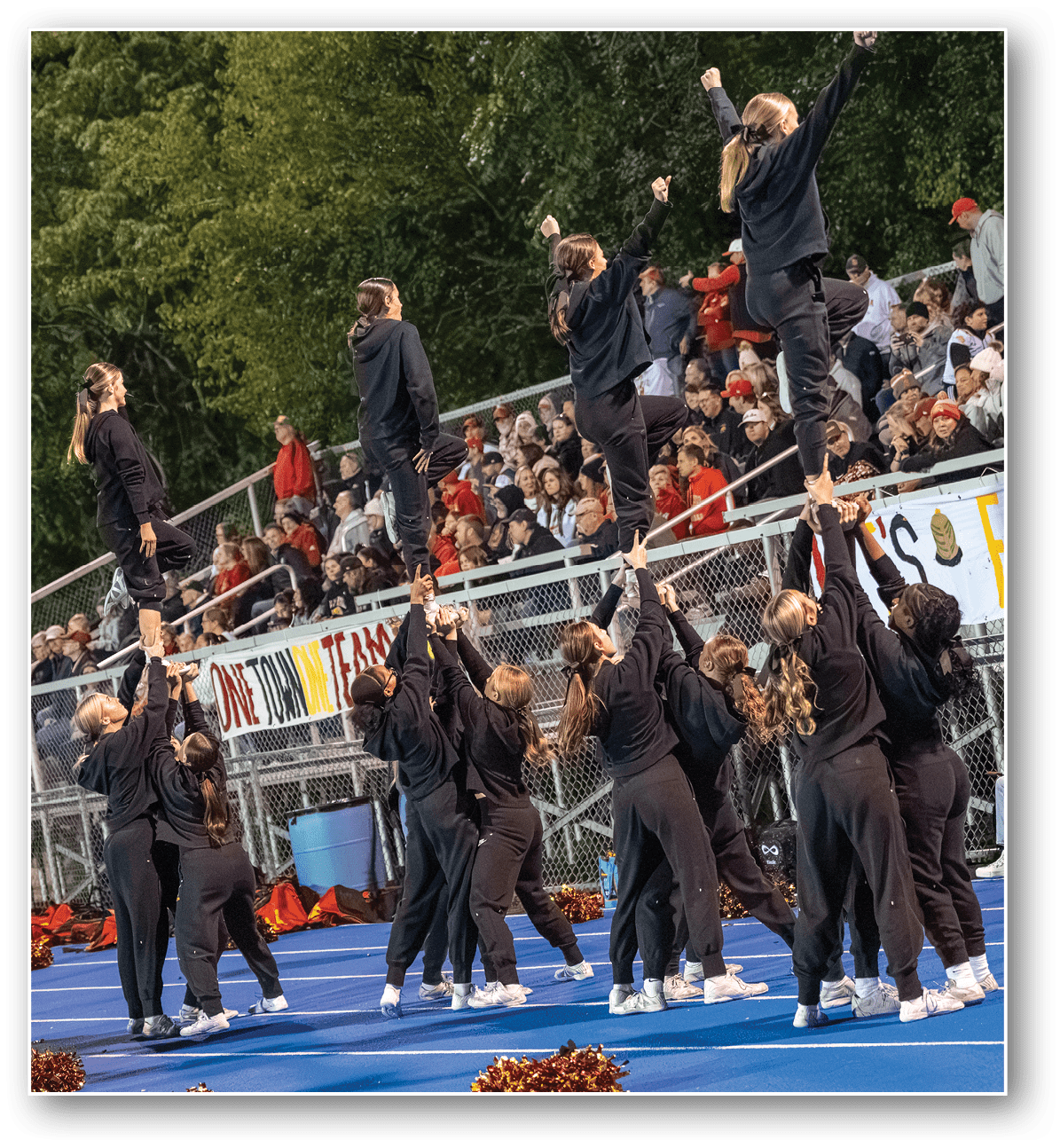 A group of football players on a field. Description generated by AI