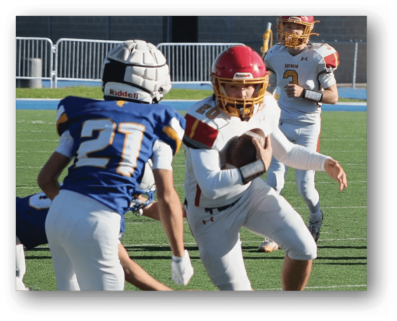 Three football players in blue and white uniforms running on a field. Description generated by AI