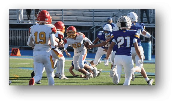 A group of football players on a field. Description generated by AI