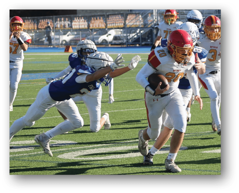 Three football players in blue and white uniforms running on a field. Description generated by AI