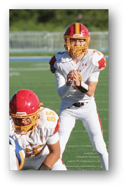 A football player catching a ball. Description generated by AI