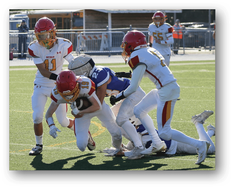 Three football players in blue and white uniforms running on a field. Description generated by AI