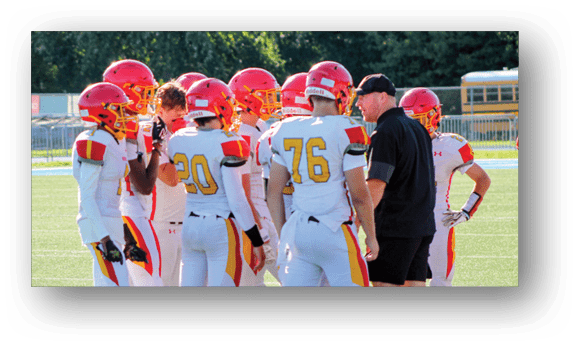 A group of football players on a field. Description generated by AI
