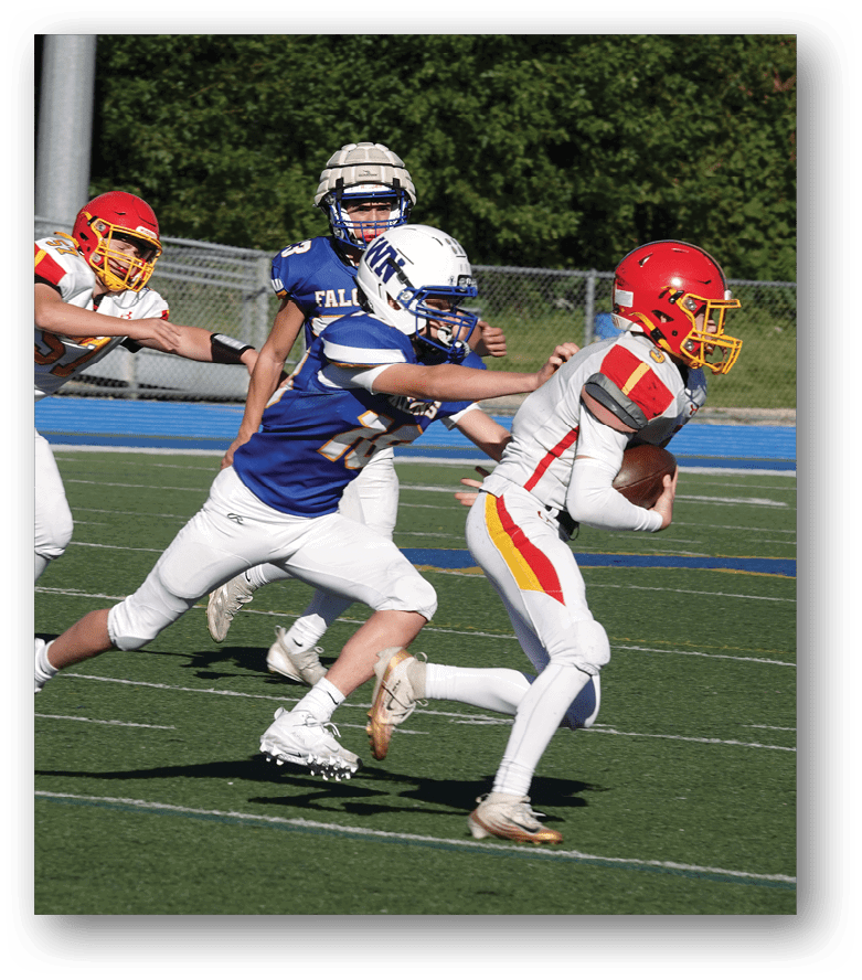 Three football players in blue and white uniforms running on a field. Description generated by AI