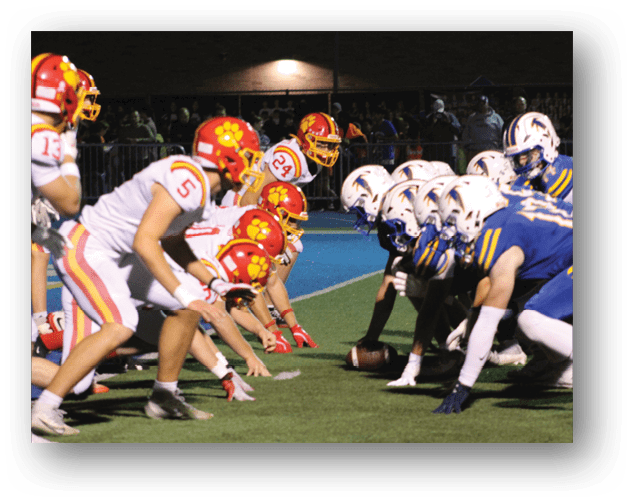 A football game is taking place on a field with players wearing blue and white uniforms. Description generated by AI