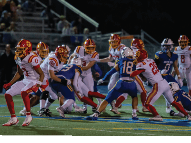 A group of football players in black and white uniforms are on the field. AI generated content