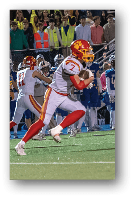 Two football players wearing blue and white uniforms. Description generated by AI
